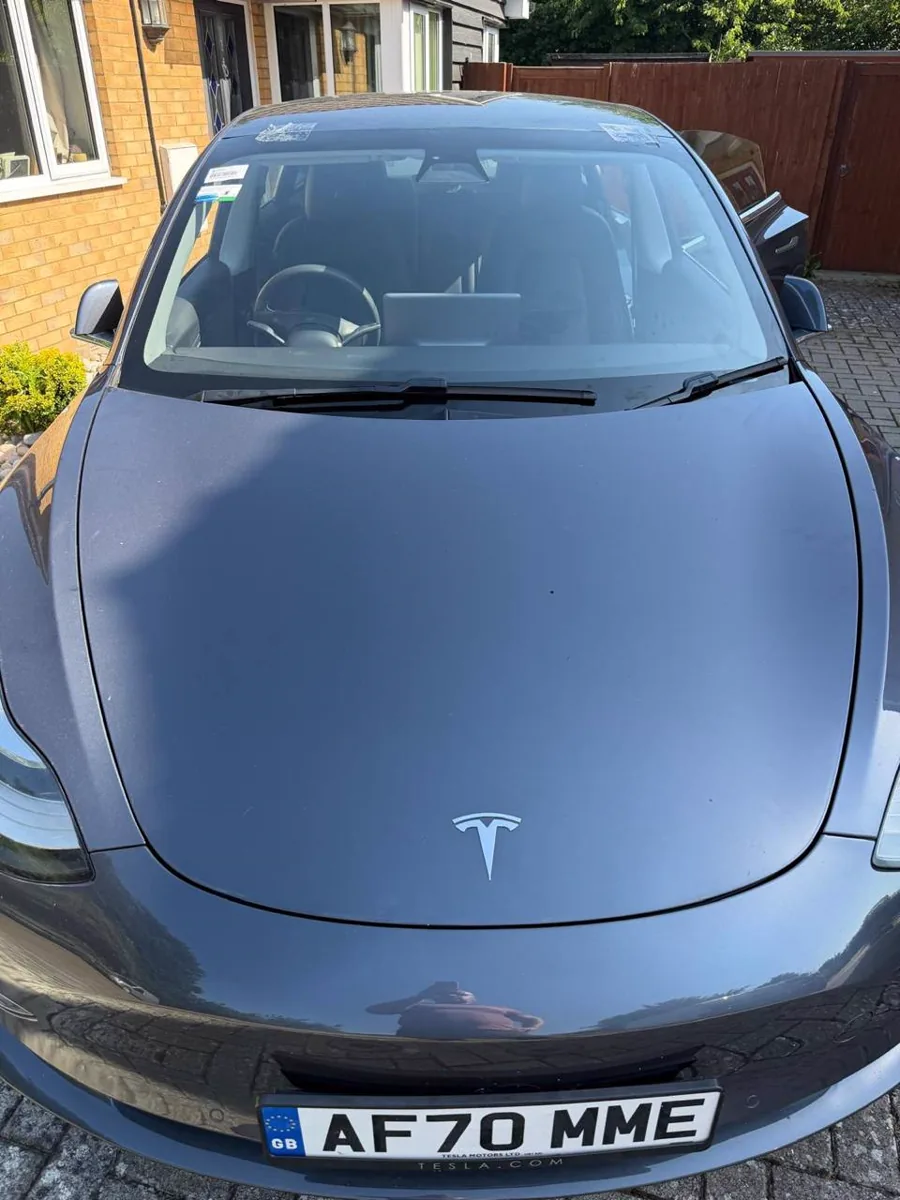 Completed windscreen work on a blue Tesla